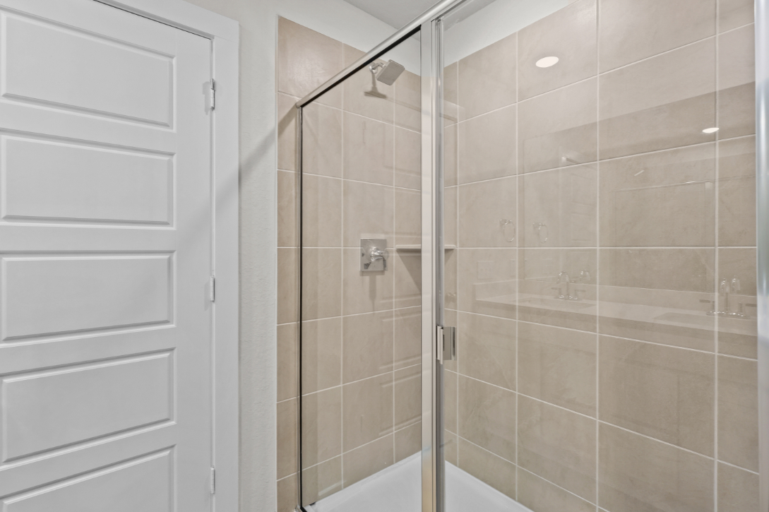 A shower with a glass door.