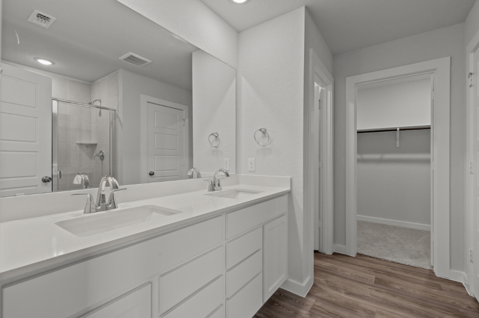 A bathroom with a large mirror.