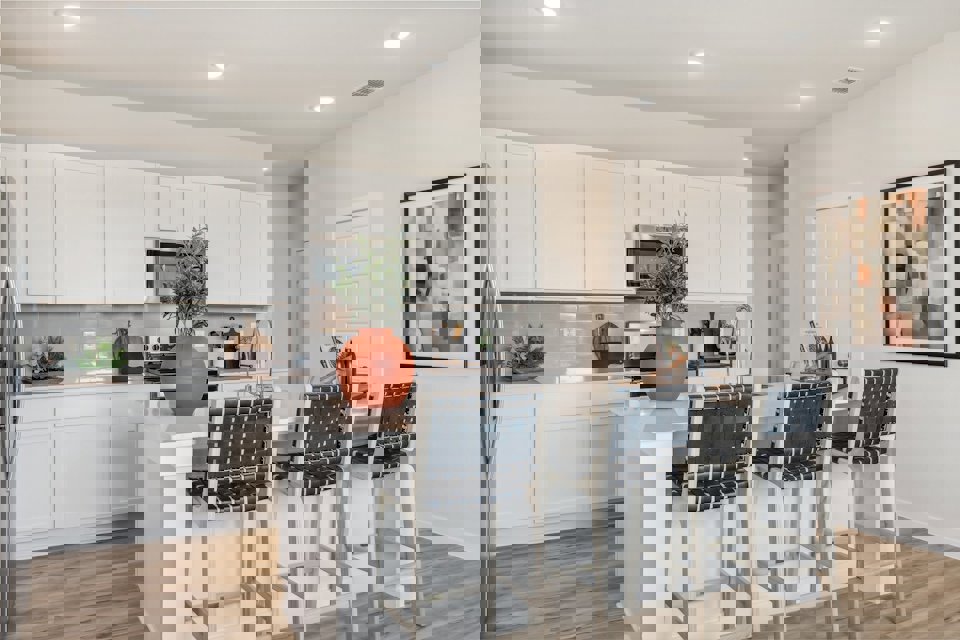 A kitchen with white cabinets.