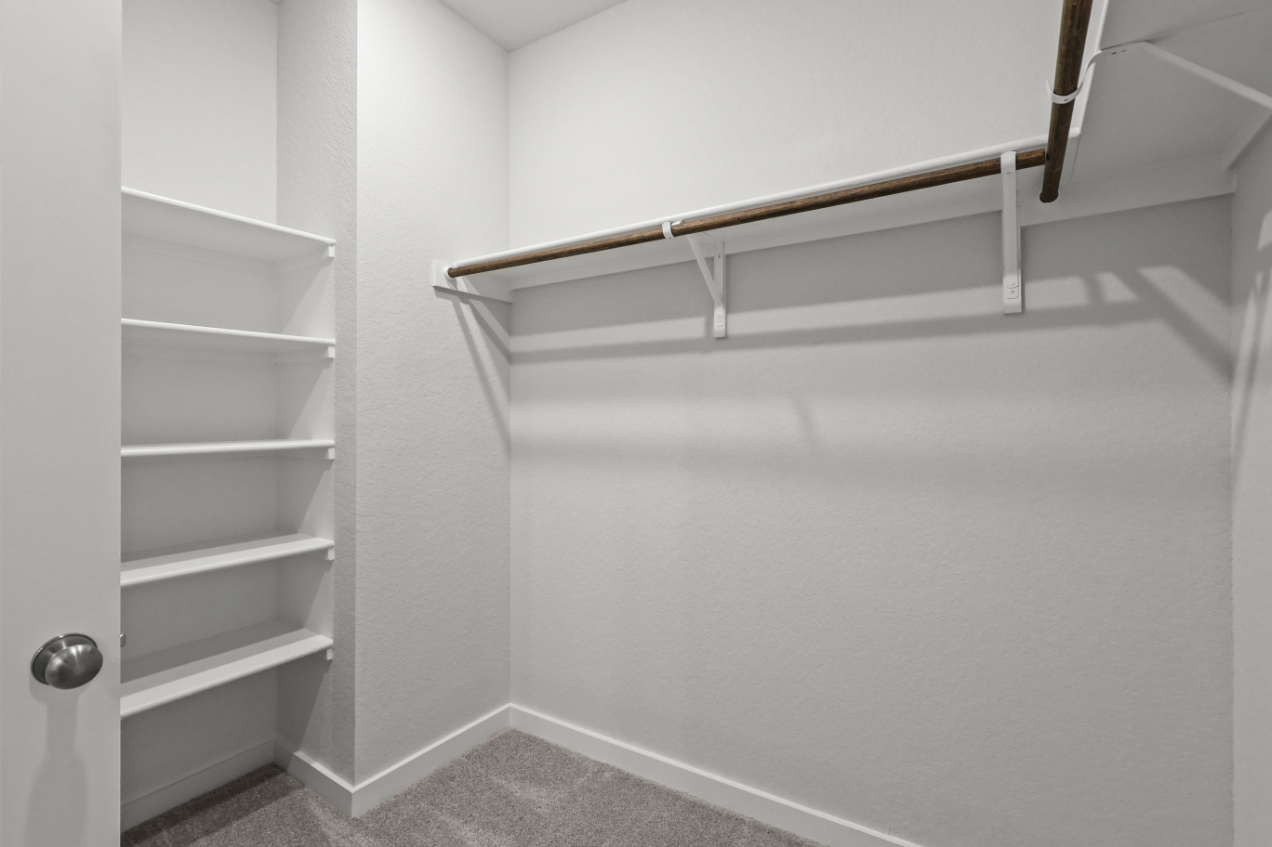 A white staircase with a metal railing.