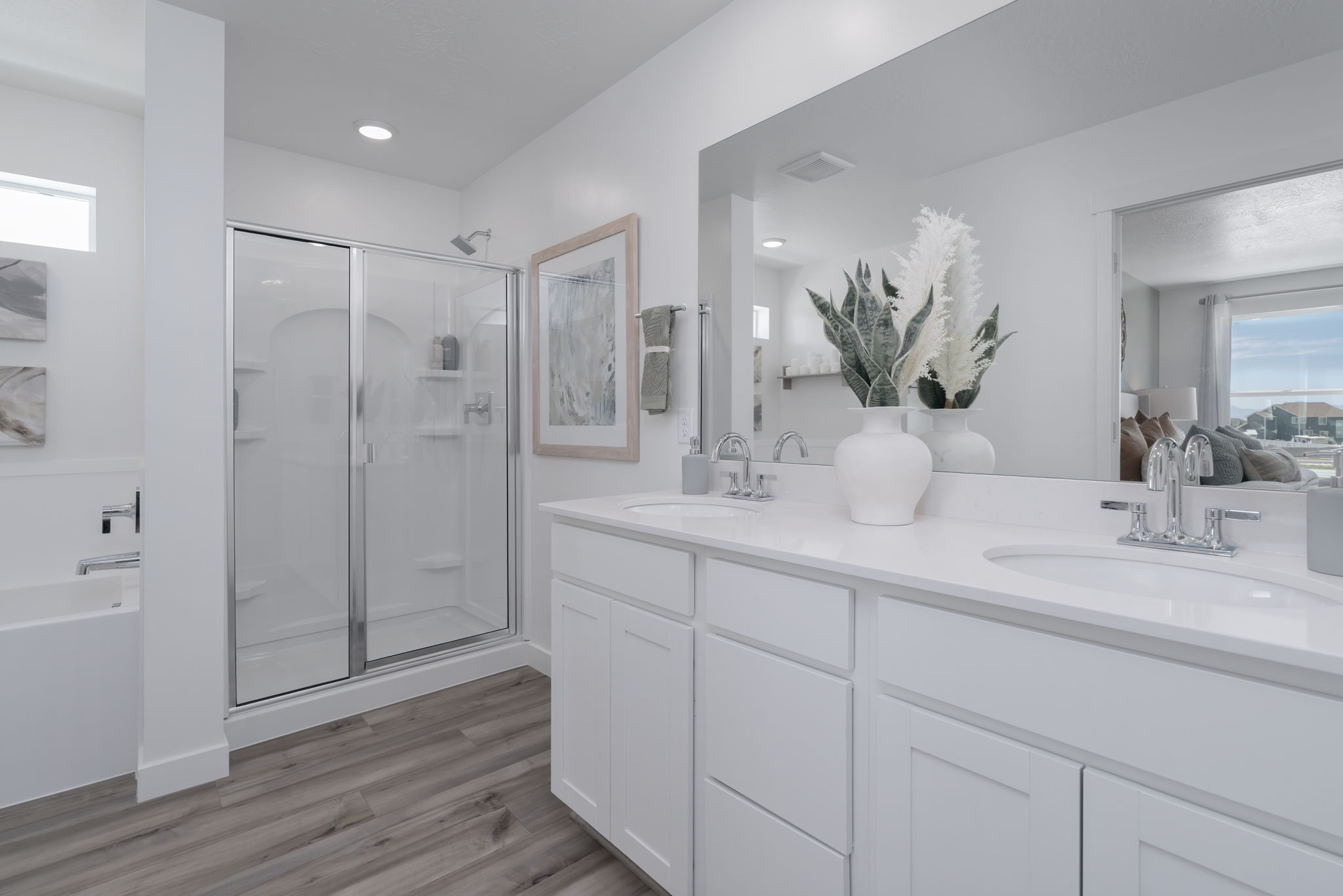 A bathroom with white cabinets.