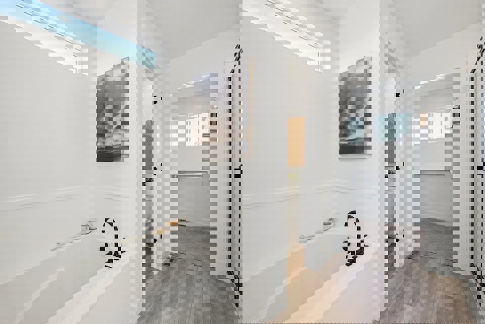 A bathroom with a tub and a sink.