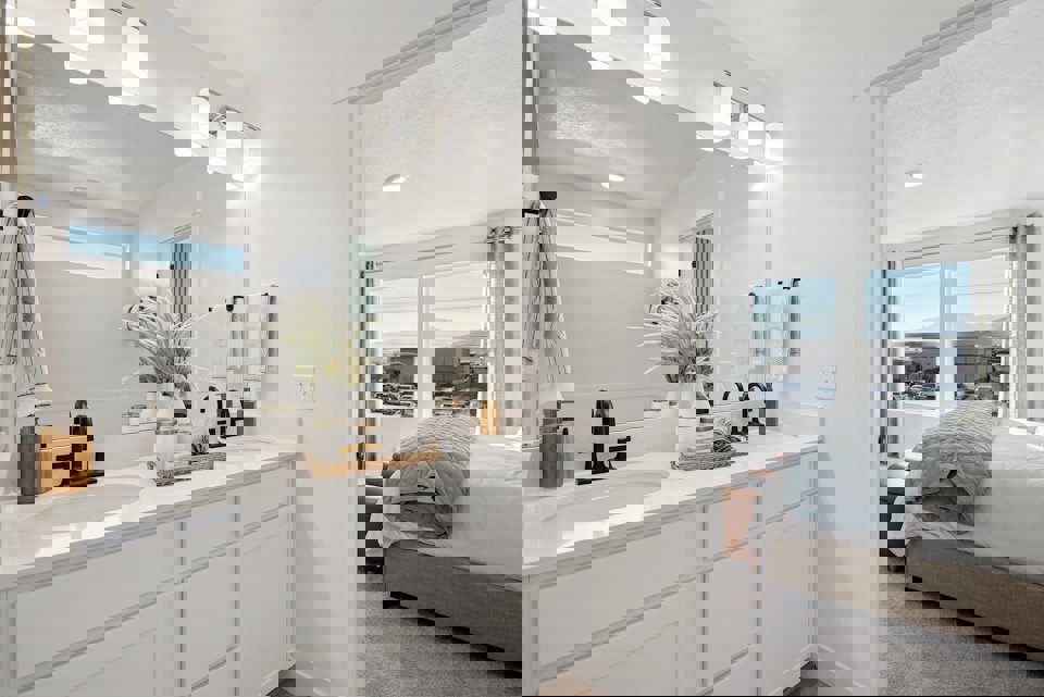 A bathroom with a large mirror.