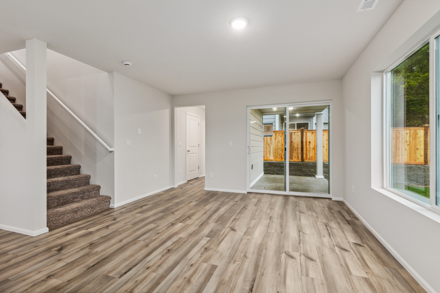 A room with a wood floor and windows.