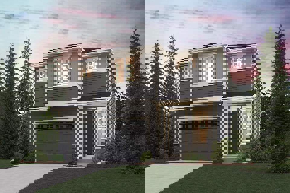 A house with a garage and trees around it.