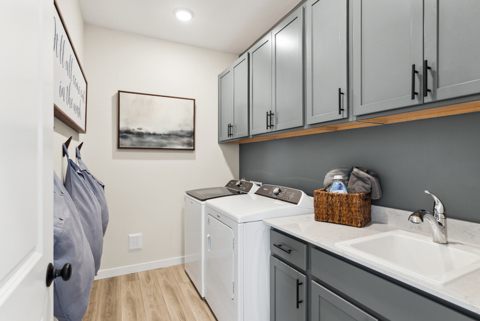 A kitchen with white cabinets.