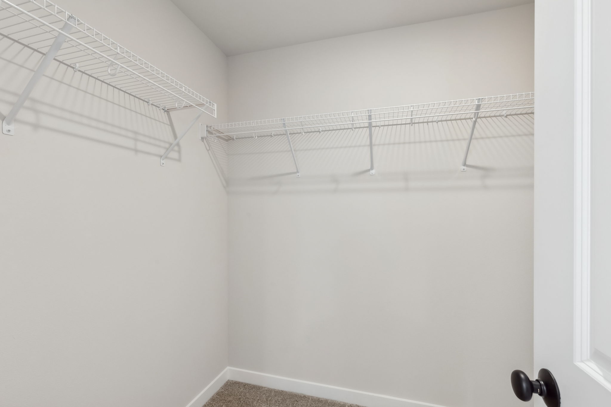 A white wall with a metal railing.