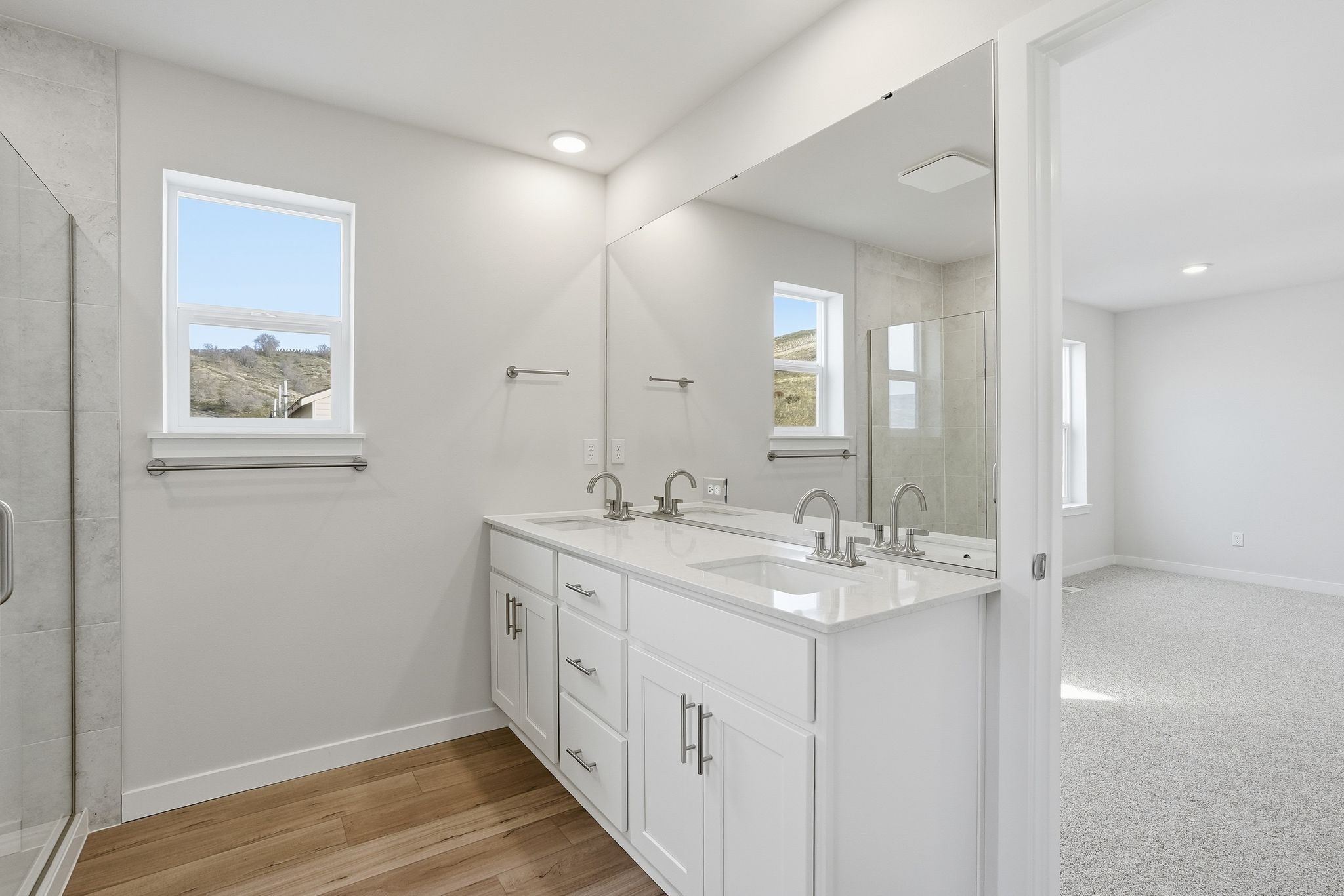 A bathroom with a large mirror.