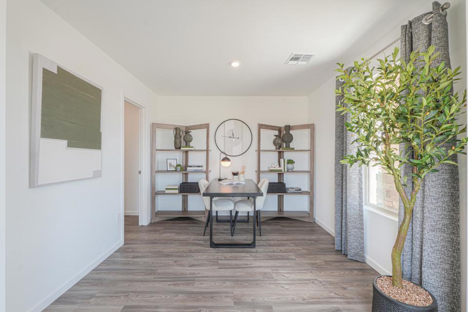 A room with a table and shelves.