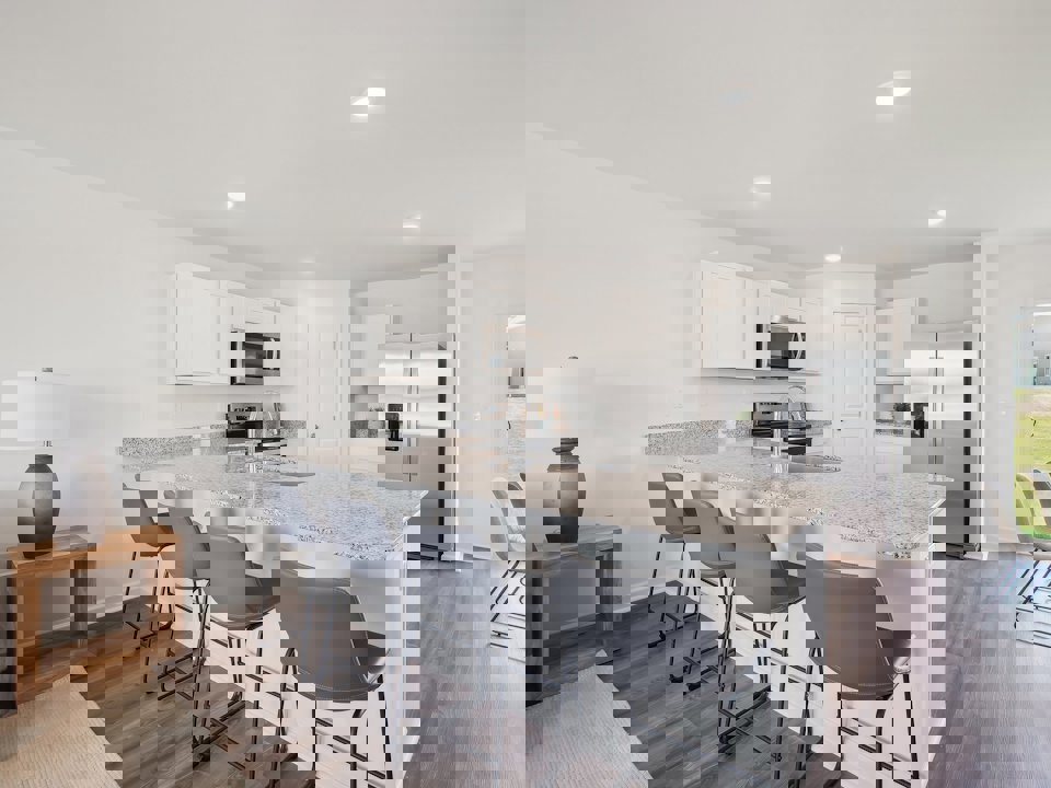 A kitchen with a dining table and chairs.