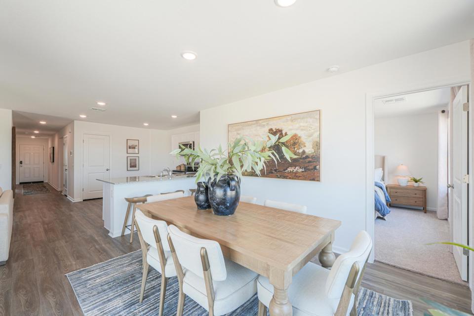 A dining room with a table and chairs.