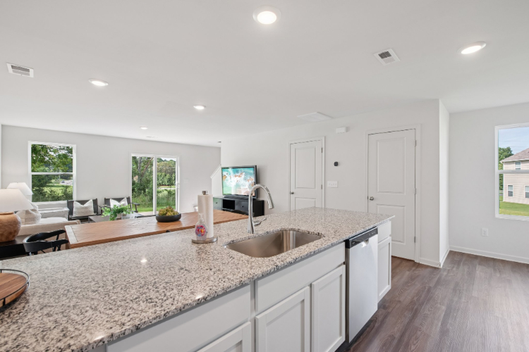 A kitchen with white cabinets.