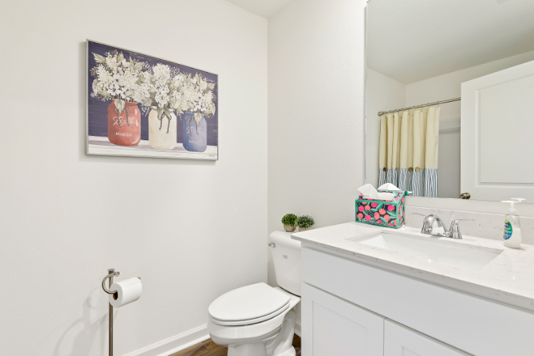 A bathroom with a toilet and sink.