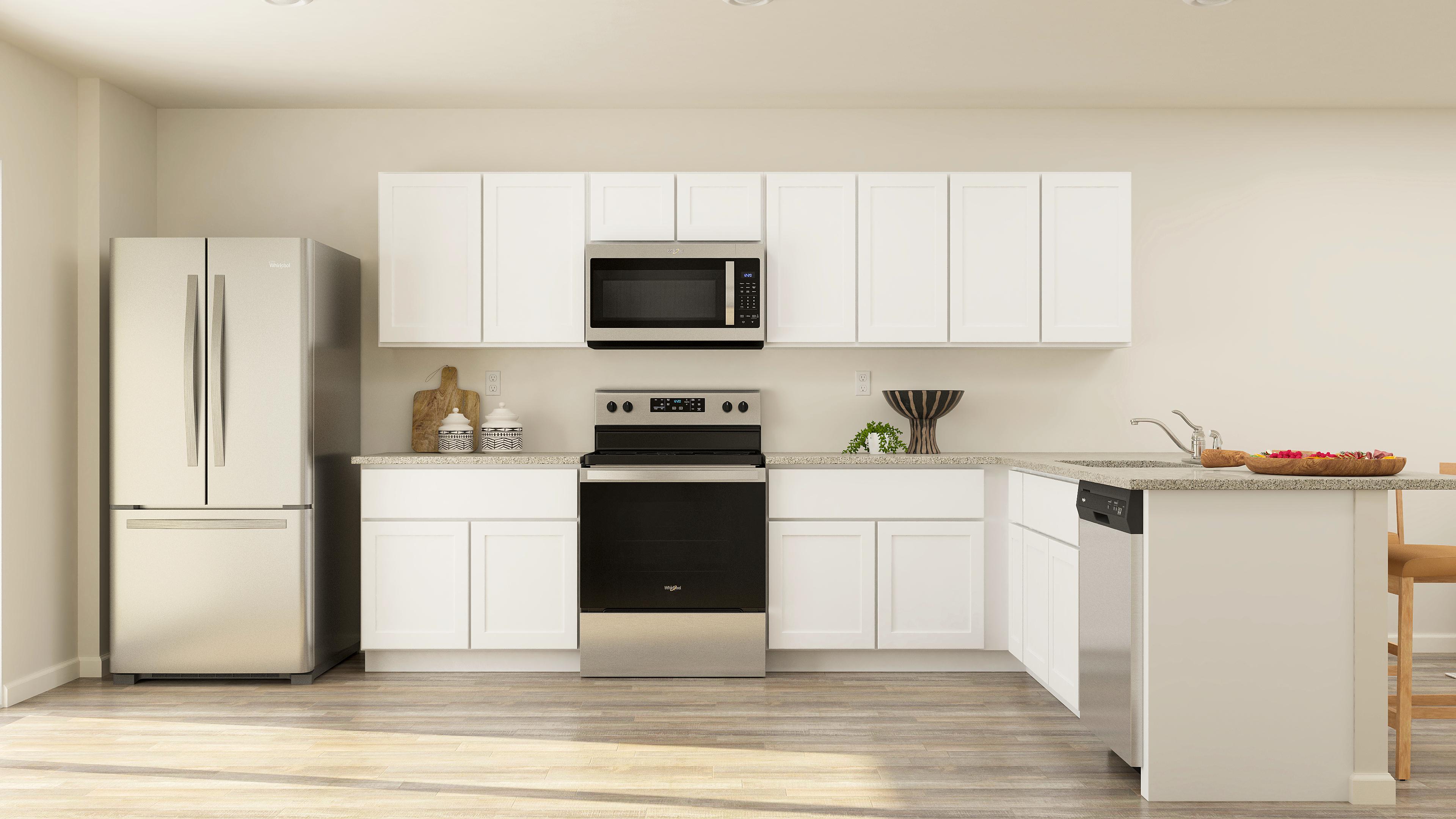 A kitchen with white cabinets.