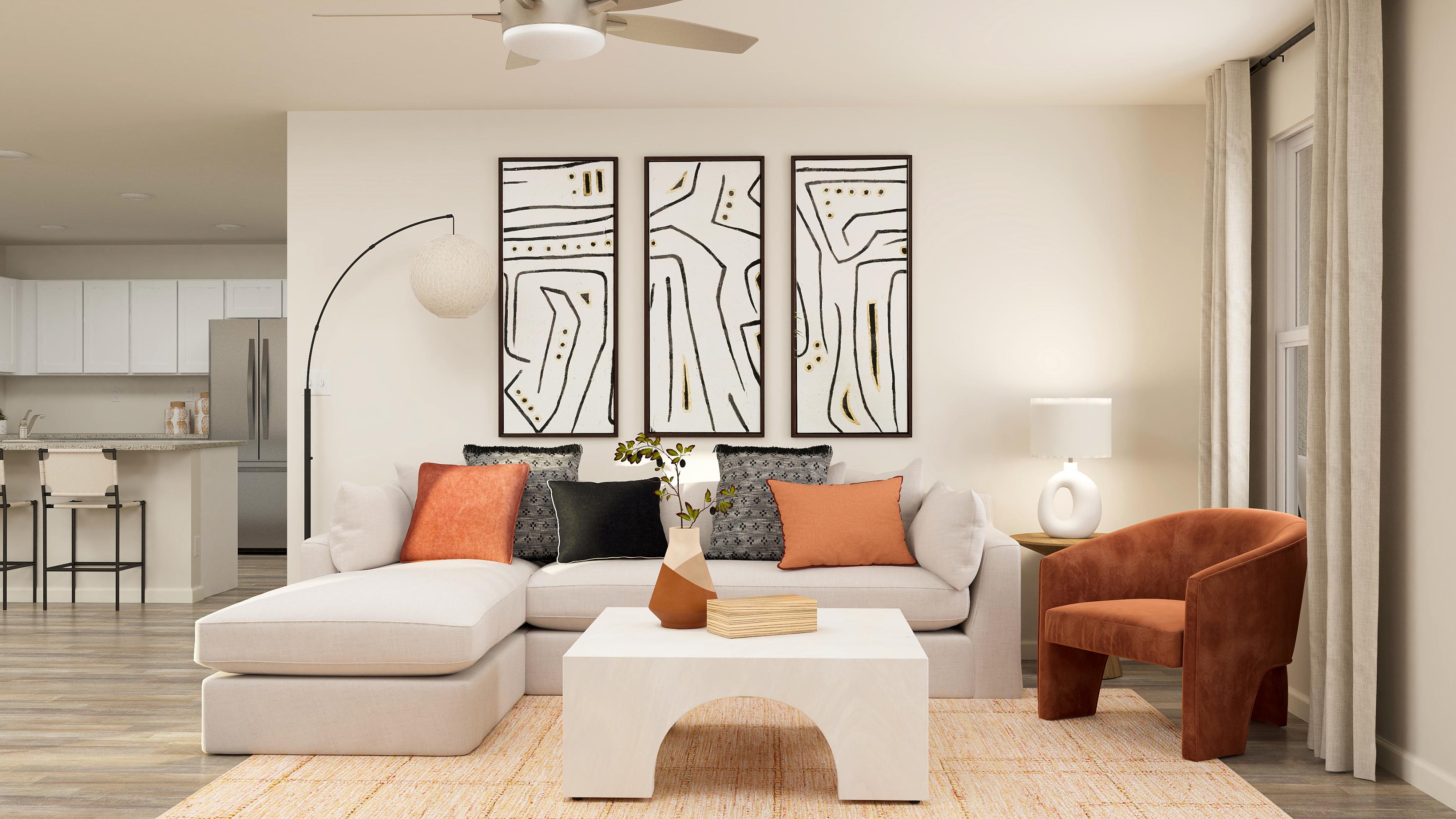 A living room with a white couch and a table.