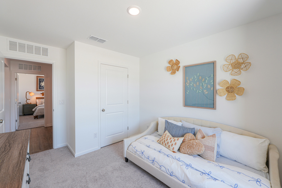 A room with a couch and a mirror.