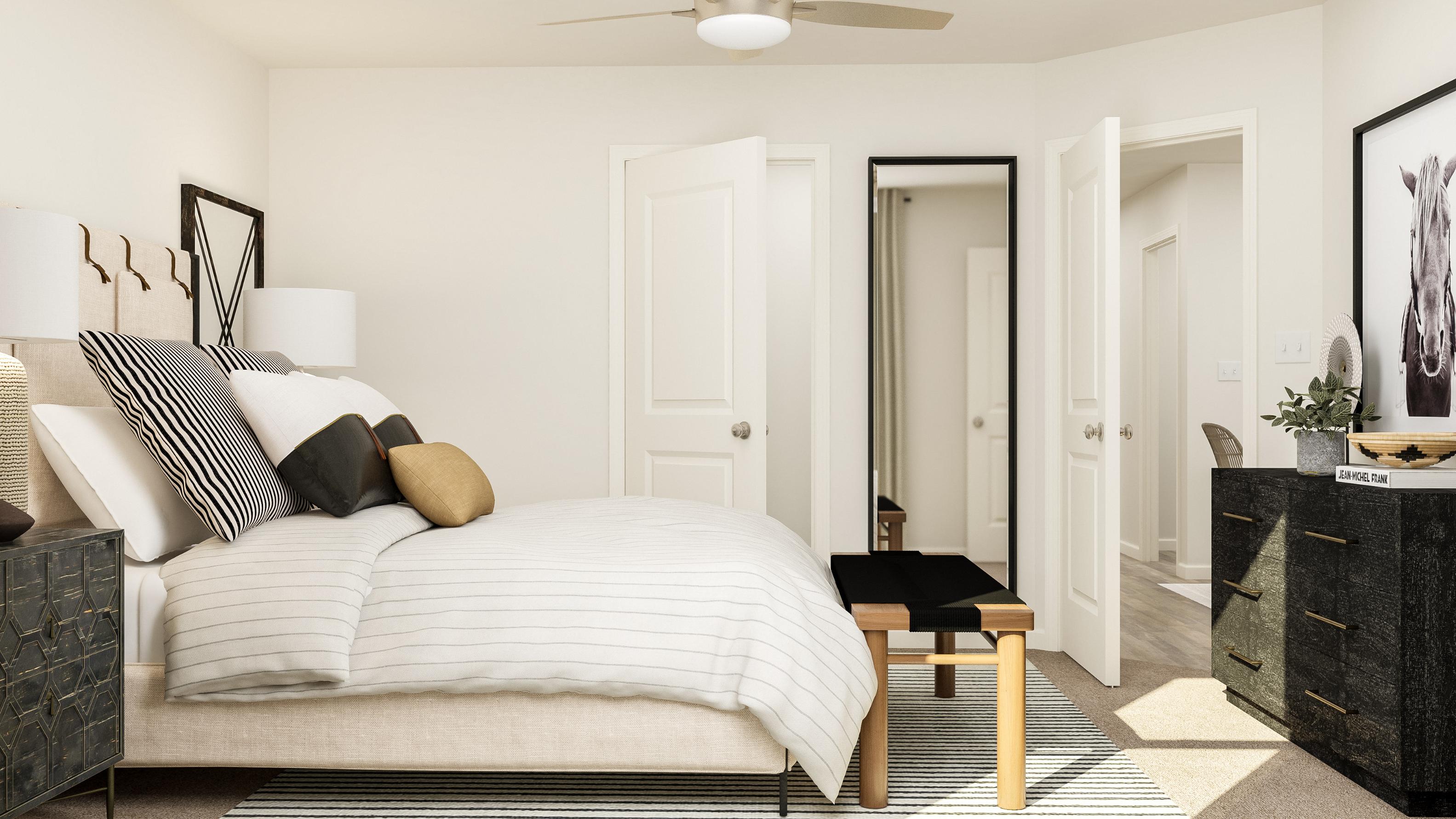 A bedroom with a bed and a table.