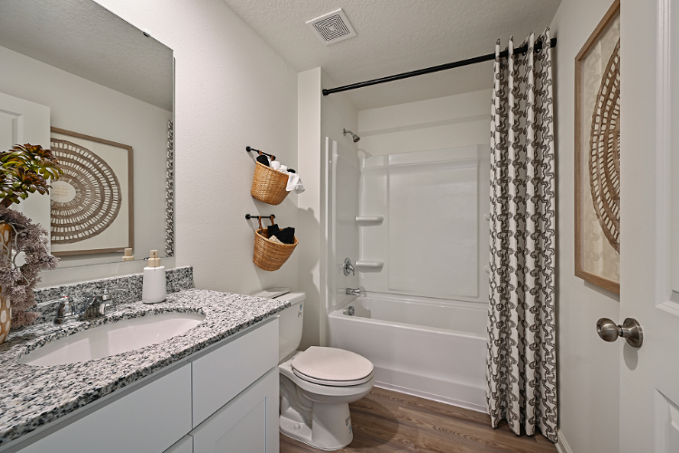 A bathroom with a tub sink and toilet.