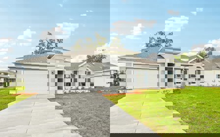 A white house with a driveway.