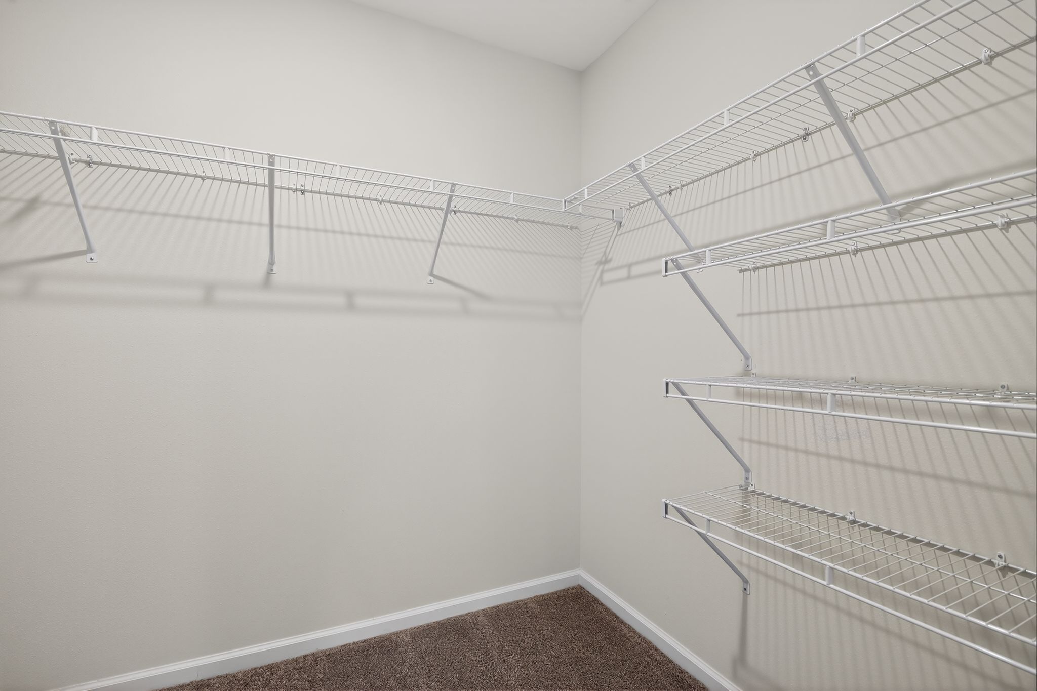 A white wall with a metal railing.