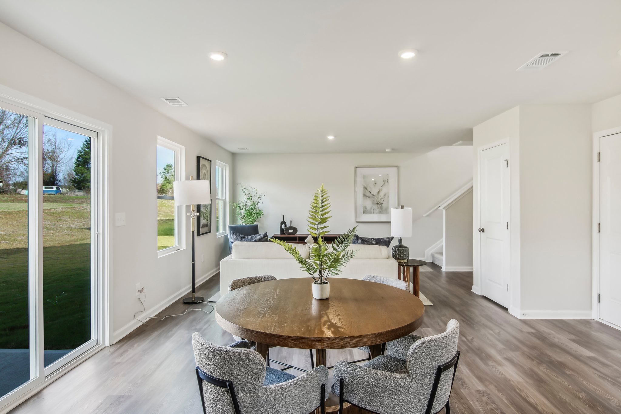 A dining room with a large glass door and a large window.