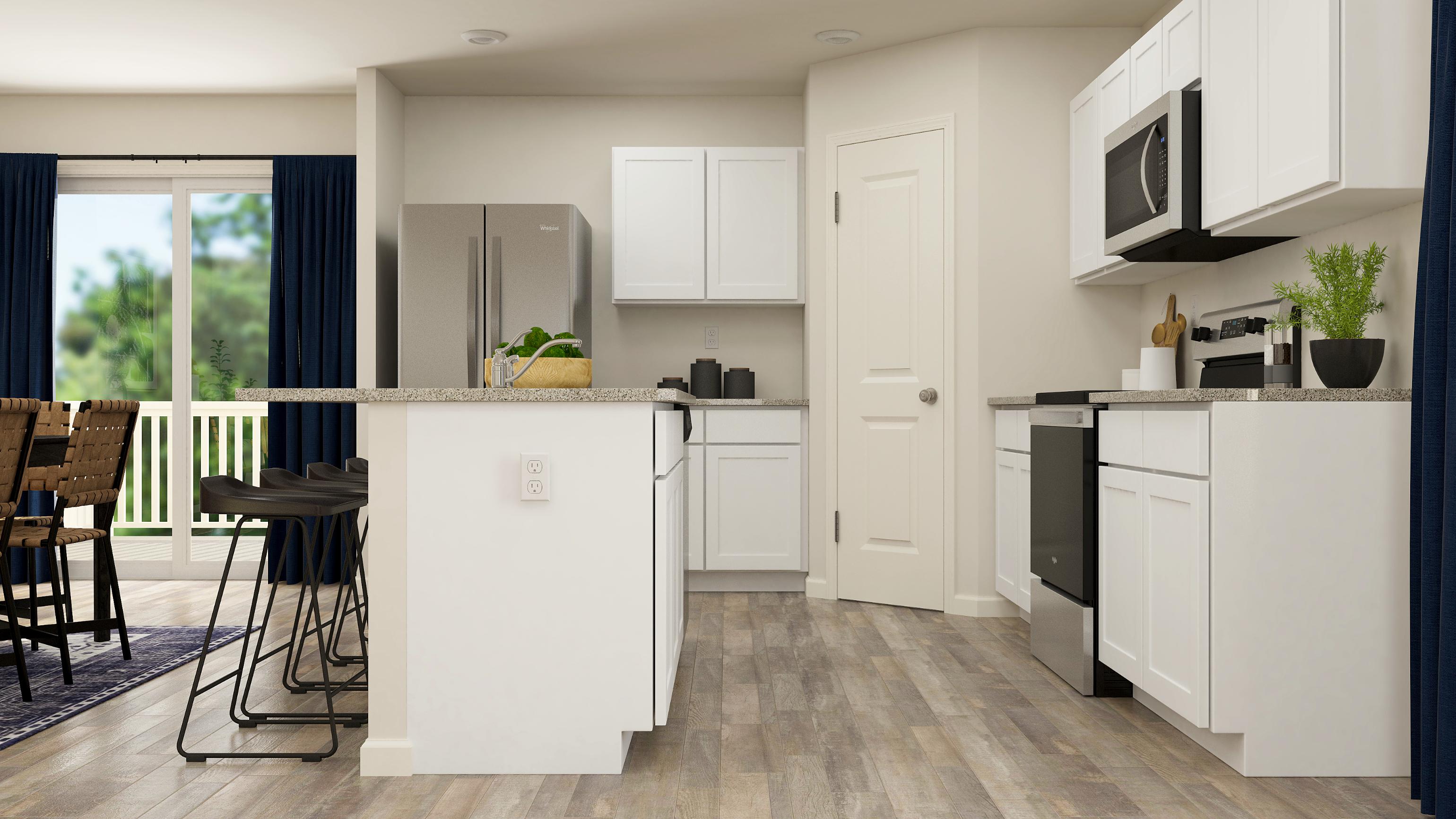 A kitchen with white cabinets.