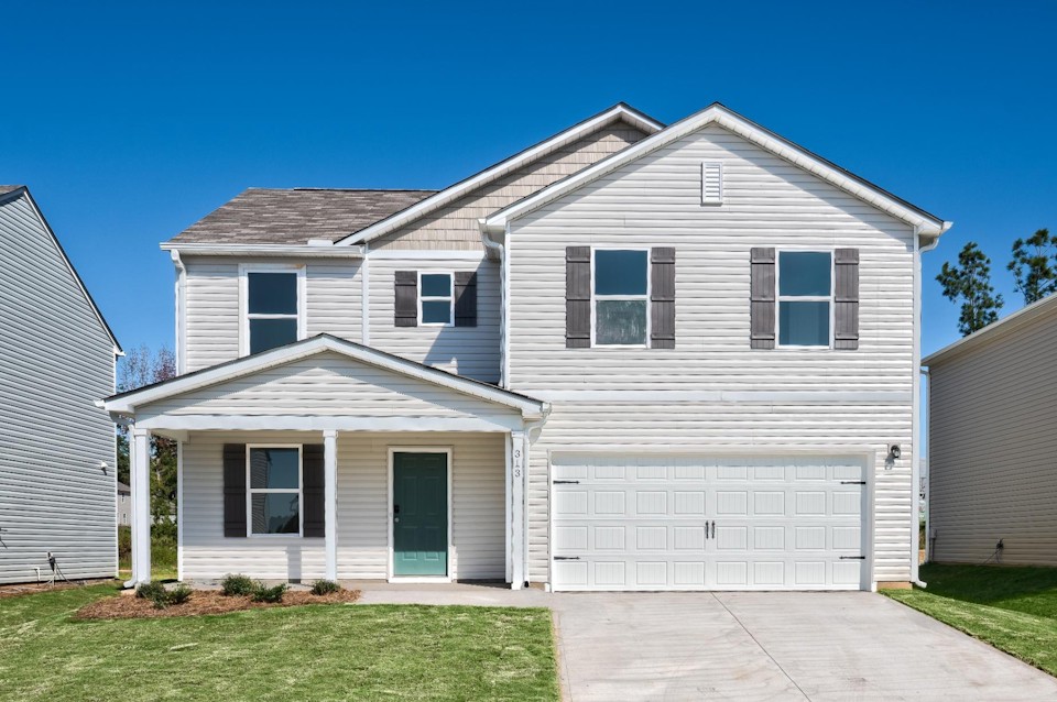 A white house with a garage.