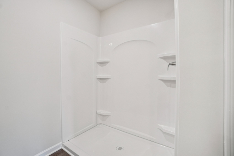 A white bathroom with a glass shower.