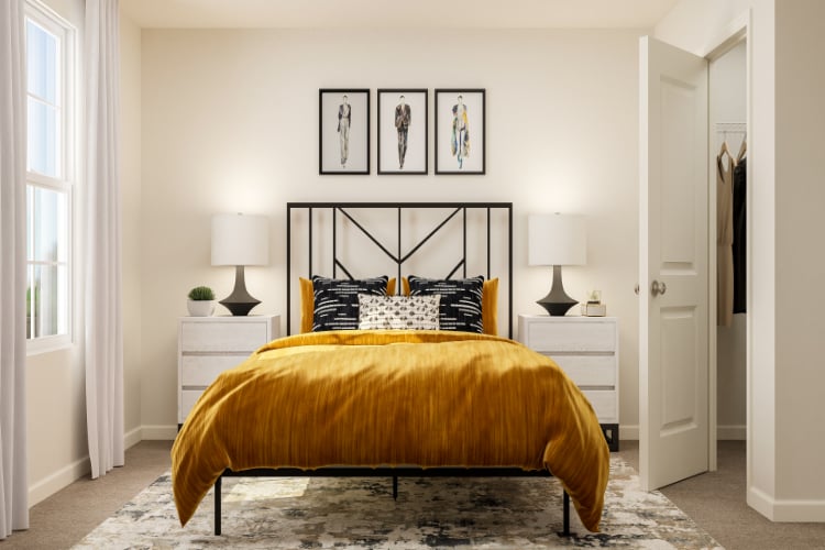 A bedroom with a bed and lamps.