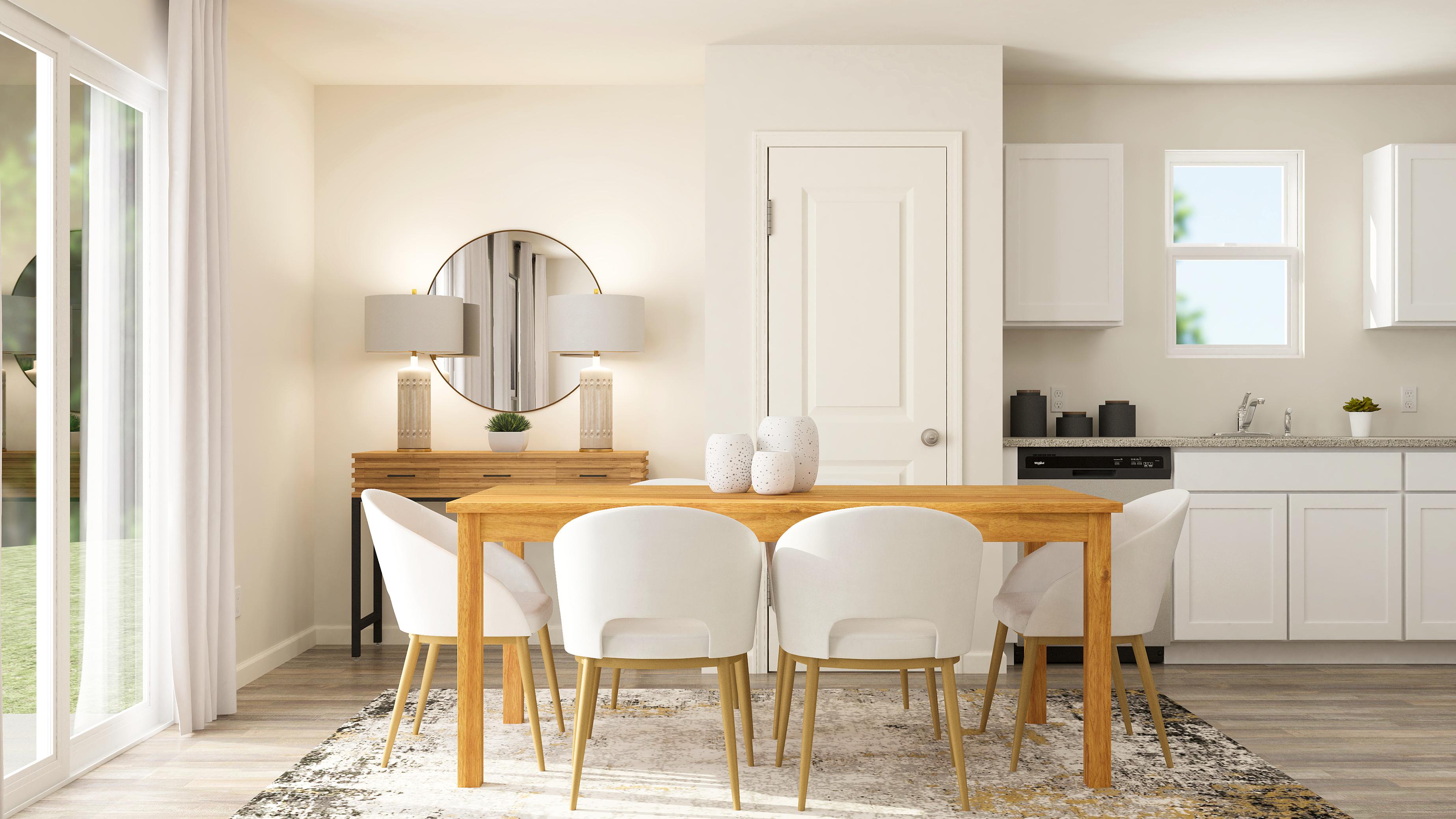 A dining room with a table and chairs.