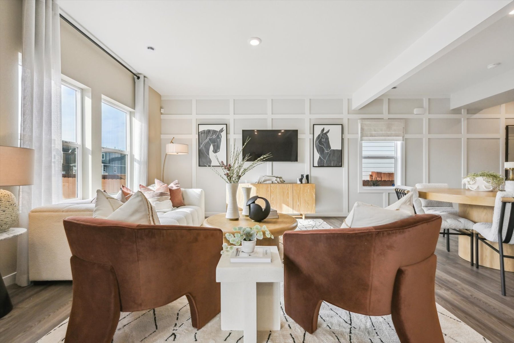 A living room with a couch and chairs.